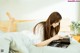 A woman laying on a bed reading a book.