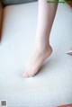 A close up of a woman's bare feet on a mat.