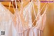 A row of wedding dresses hanging on a rack.