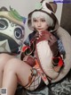 A woman sitting on a bed holding a stuffed animal.